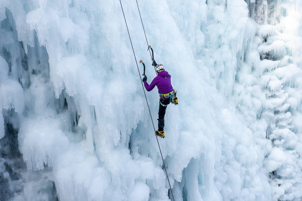 Woman climbing an icy slope - Photo, image