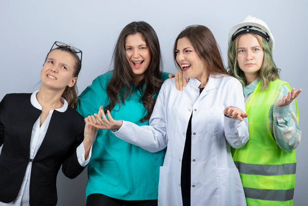 Portrait of happy people of different professions standing together on white background. High quality photo - Photo, Image