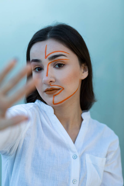 Portrait of young woman with painted face posing . High quality photo - 写真・画像