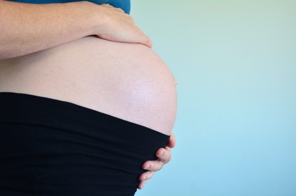 Pregnant woman with baby - Фото, зображення