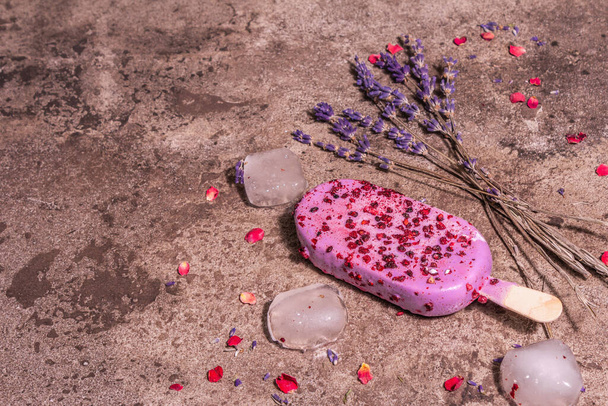 Lavender ice cream. Flower bouquet, pink rose petals. Trendy hard light, dark shadow. Marble stone background, copy space, flat lay - Photo, Image