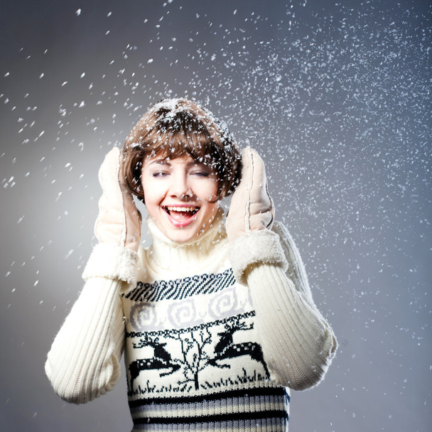 Young beautiful girl rejoices to snow, On a dark blue background - Fotografie, Obrázek