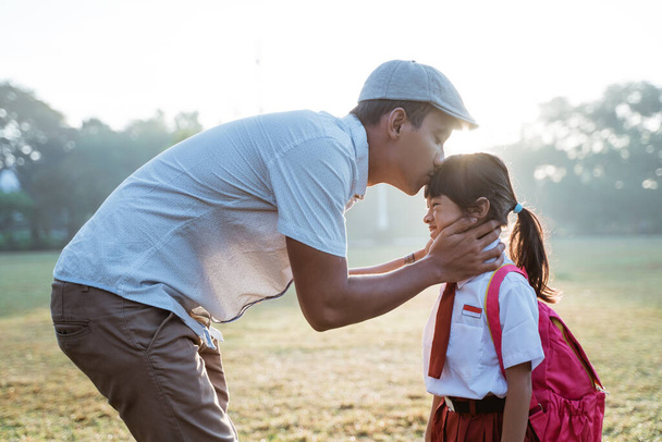 father kiss her daughter forehead when taking her to school in the morning - Photo, Image