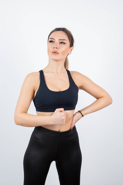 Portrait of young fit woman in black crop top posing. High quality photo - Φωτογραφία, εικόνα