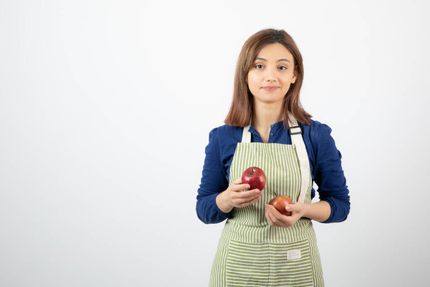 Image of young woman holding red apples on white background. High quality photo - Φωτογραφία, εικόνα