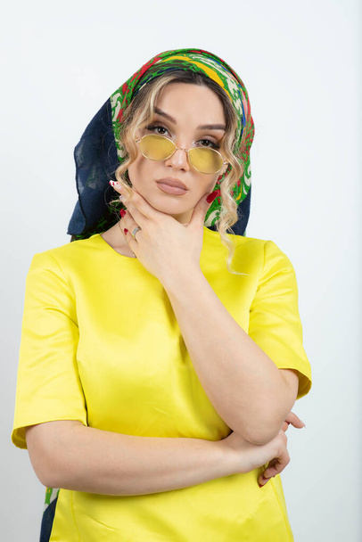 Picture of beautiful woman in headkerchief posing in glasses . High quality photo - Foto, afbeelding