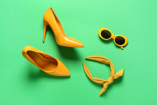 Set of female accessories with sunglasses on color background - Photo, Image