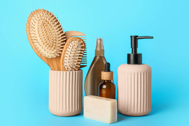 Hair brushes, comb and cosmetics on color background - Photo, Image