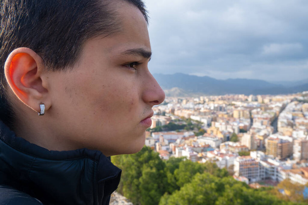 Cierre de Joven mirando de lado a la ciudad de Málaga en España. - Foto, imagen