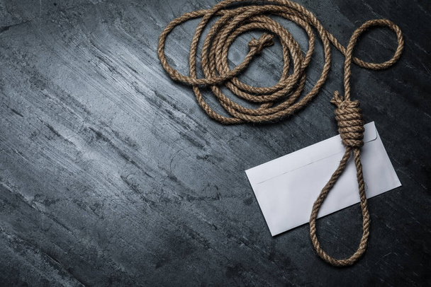 Rope noose and blank envelope on black table, flat lay. Space for text - Fotoğraf, Görsel