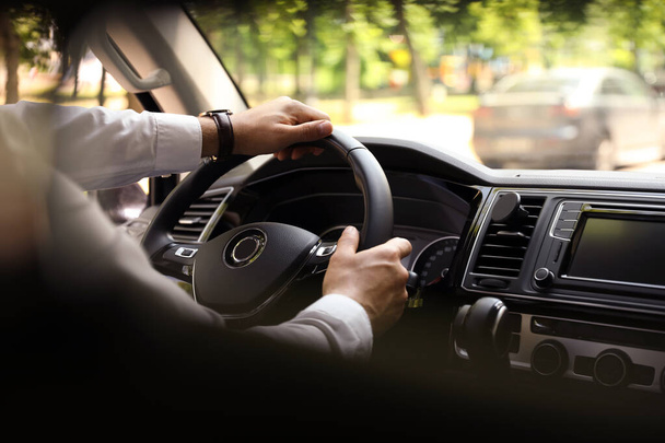 Man driving his car, closeup view of hands on steering wheel - Zdjęcie, obraz