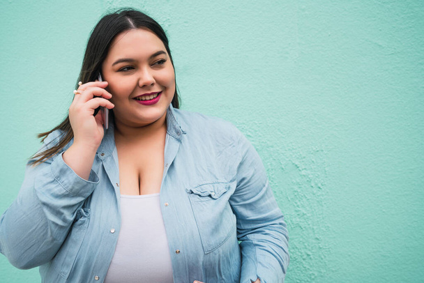 Young plus size woman talking on the phone. - Photo, image