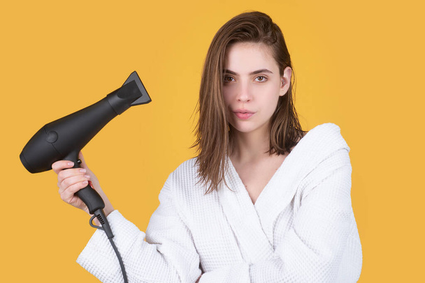 Woman using hair dryer. Young girl with drying hair with hair dry. Women hair care. - Fotoğraf, Görsel