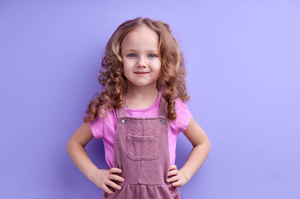 Cute Pretty Smiling Child Girl Isolated On Purple Background, Look At Camera - Φωτογραφία, εικόνα