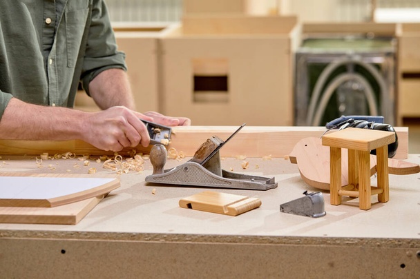 Cropped male carpenter work in carpentry using tools. Man is successful entrepreneur - 写真・画像