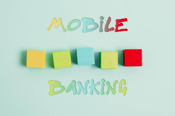 Inspiration showing sign Mobile Banking. Conceptual photo to create financial transactions with the use of smartphone Stack of Sample Cube Rectangular Boxes On Surface Polished With Multi-Colour - Zdjęcie, obraz