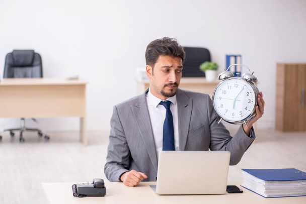 Young male employee in time management concept - Φωτογραφία, εικόνα