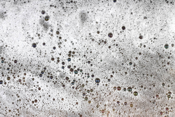 Detergent bubbles float in the waste water. - Photo, Image