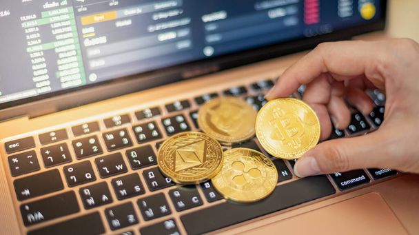 One Golden Bitcoin with Cryptocurrency on hand businesswoman with the cryptocurrency graph for trading. - Photo, Image