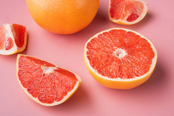 Lédús rózsaszín grapefruit vágott készlet, rózsaszín texturált nyári háttér - Fotó, kép