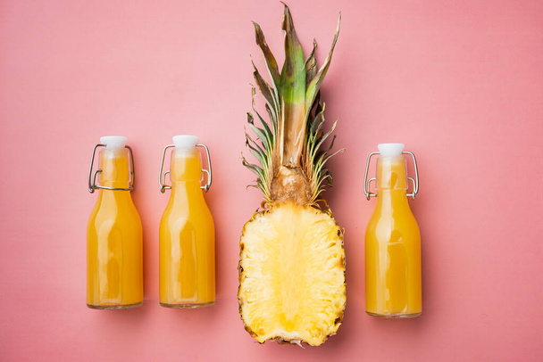 Pineapple juice set, on pink textured summer background, top view flat lay - Valokuva, kuva
