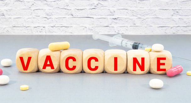 VACCINE word written on wooden block cubes isolated on white background - Фото, зображення