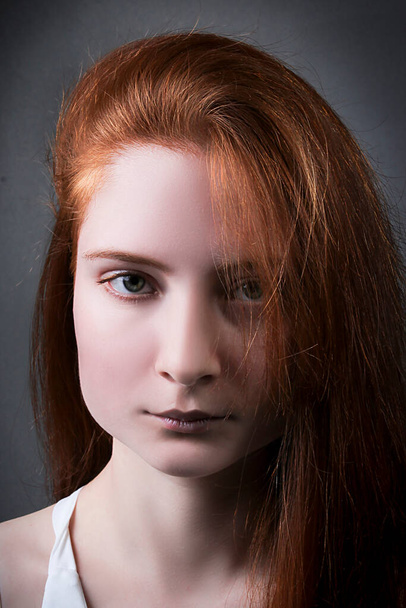 Portrait of a beautiful redhead young woman - 写真・画像