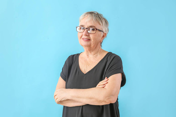 Portrait of stylish senior woman on color background - Photo, image