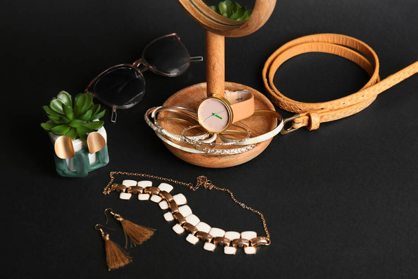 Set of female accessories and houseplant on dark background - Foto, Imagem