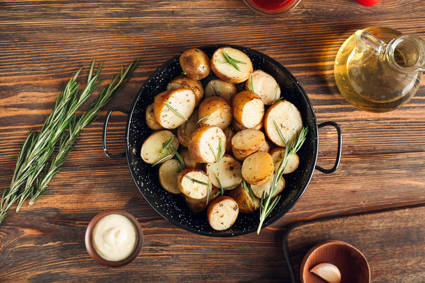 Frying pan with cooked potatoes on table - Photo, image