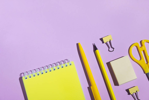 School stationery on bright purple background. Back to school concept. Top view, flat lay, copy space, minimal - Photo, Image
