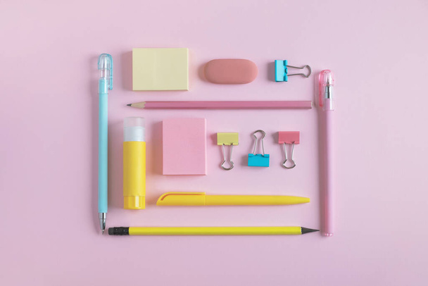 Stationery supplies on pastel pink background. Back to school concept. Top view, flat lay, minimal - Foto, afbeelding