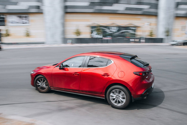 Ukraine, Kyiv - 27 June 2021: Red MAZDA 3 car moving on the street. Editorial - Photo, Image