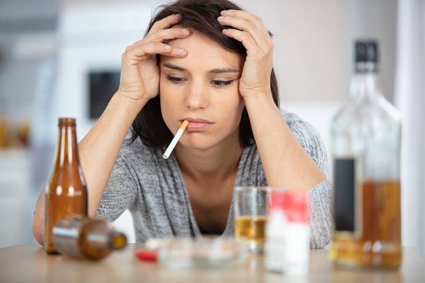 drunk depressed woman smoking and drinking at home - Foto, Imagem