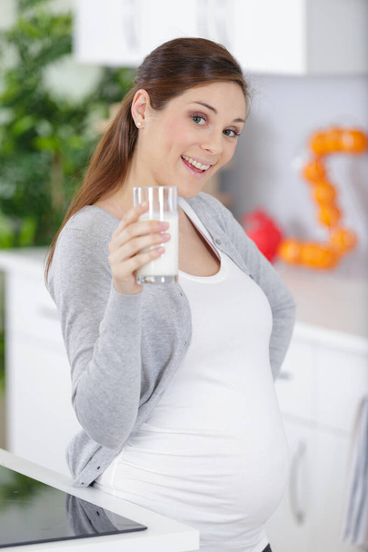 young pregnant woman with glass of milk - Photo, Image