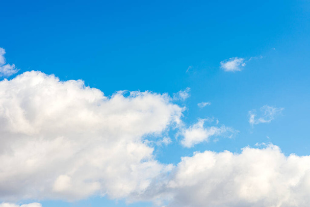 white fluffy clouds in the blue sky background.Blue cloudy white sky in the nice blue heaven sky. - Photo, Image