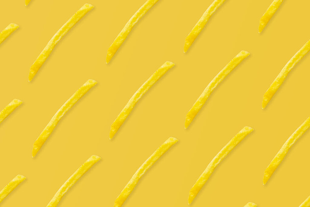 french fries pattern on yellow background top view flat lay - Фото, изображение