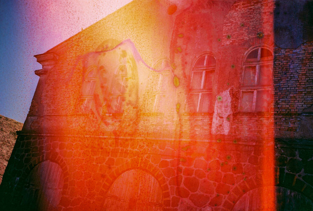 Vintage distressed blurry and grained photo. Damaged camera film. Mystical, psychedelic, nostalgic picture. Old house view. - Photo, Image