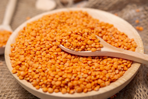 orange lentils in wooden bowl. Healthy lifestyle. Vegetarian and vegan diet. - Photo, Image