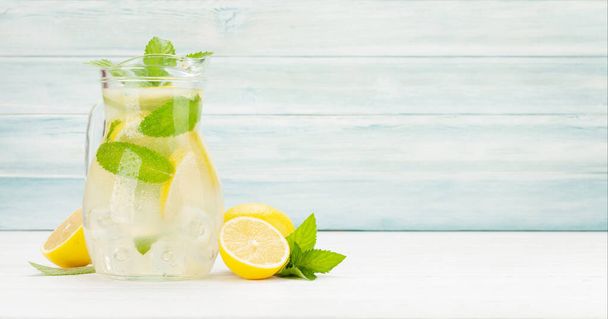 Fresh homemade lemonade with lemon and mint. With copy space - Fotó, kép