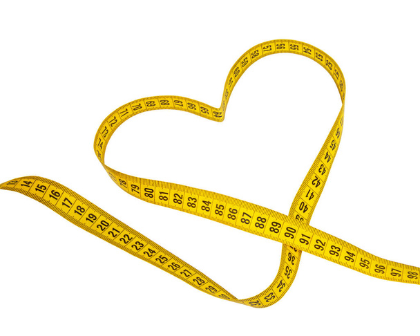 Yellow heart tape measure isolated on the white background - Photo, Image