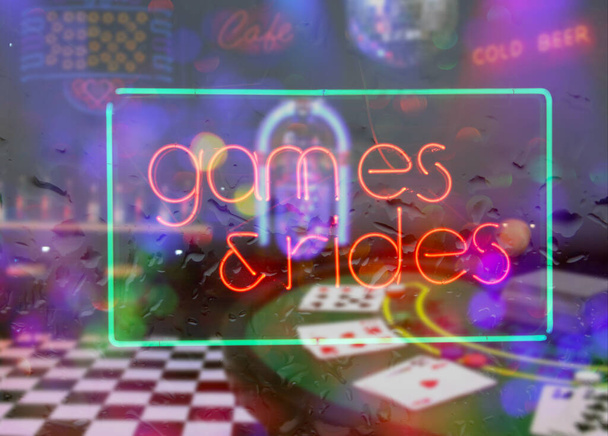 Neon Rainy Window Blur Image, Games and Rides Sign Composite Image Neon Sign - Photo, Image