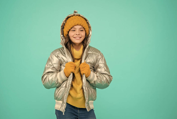 Winter warmness. accessories shop for kids. enjoy weather on christmas holidays. smiling stylish child. autumn season fashion. girl in silver puffer jacket. trendy warm clothing. happy childhood - Photo, image