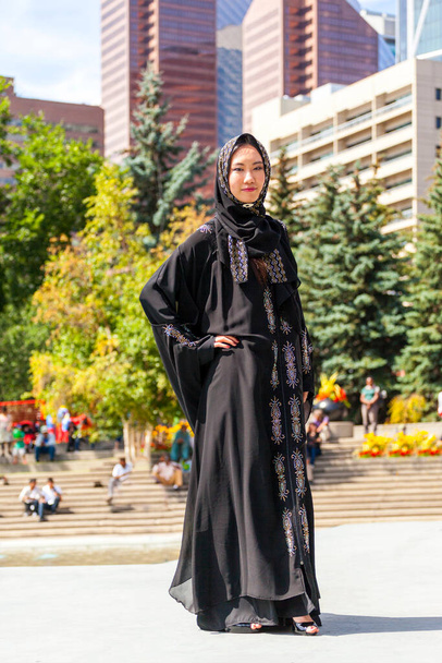 Calgary, Canada - August 10, 2014: Model showing Arab style fashion in public place at Olympic Plaza.  - Foto, immagini