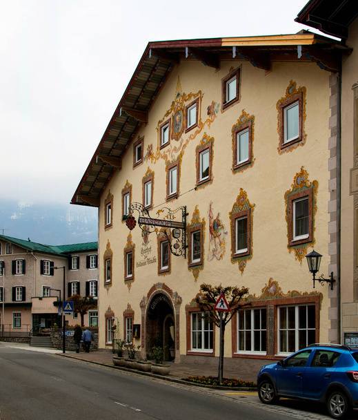 Golling, Austria -  April 12, 2019: Main street of the town, with traditional illustrative painting on the facades. - Фото, изображение