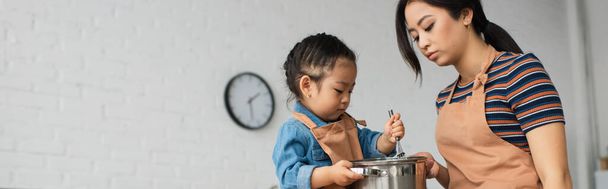 Asian mother and kid cooking together at home, banner  - Photo, Image