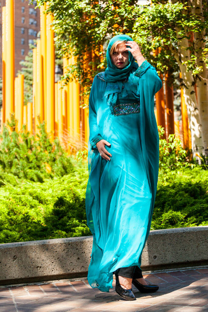 Calgary, Canada - August 10, 2014: Model showing Arab style fashion in public place at Olympic Plaza.  - Photo, Image