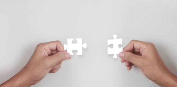Holds in hand  jigsaw puzzle. Business solutions success and strategy concept - Fotografie, Obrázek