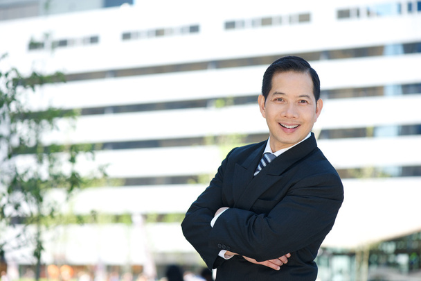 Asian business smiling with arms crossed - Photo, Image