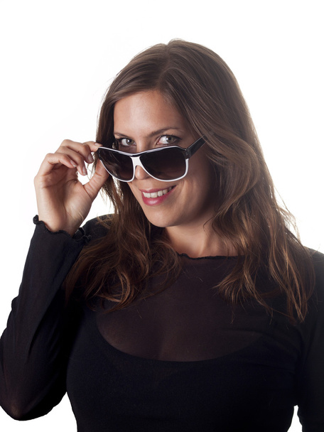 Beautiful smiling brunette looking over her sunglasses - Fotoğraf, Görsel
